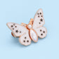 Bouton en forme de papillon qui s'adapte parfaitement